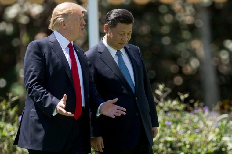 (FILES) US President Donald Trump (L) and Chinese President Xi Jinping (R) walk together at the Mar-a-Lago estate in Palm Beach, Florida, April 7, 2017. China announced on April 9, 2025, massive retaliatory tariffs on US goods, sharply escalating a trade war started by President Donald Trump and fuelling fresh panic in global markets. Trump's latest salvo of tariffs came into effect on dozens of trading partners earlier Wednesday, including punishing duties of 104 percent on imports of Chinese products. (Photo by JIM WATSON / AFP) (Photo by JIM WATSON/AFP via Getty Images)