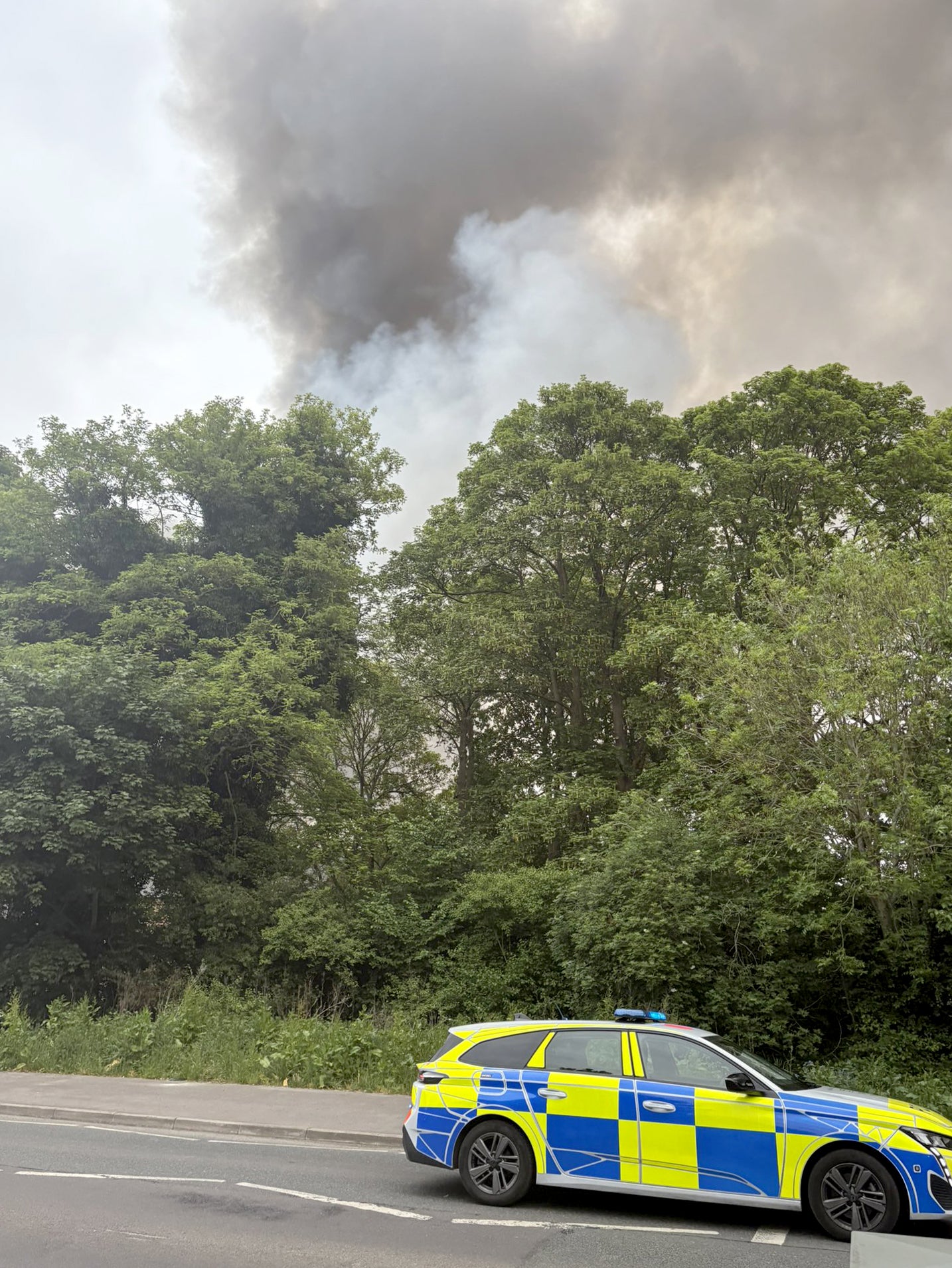 A police car near the scene of the blaze (@kajer87/Kieran McG/PA)