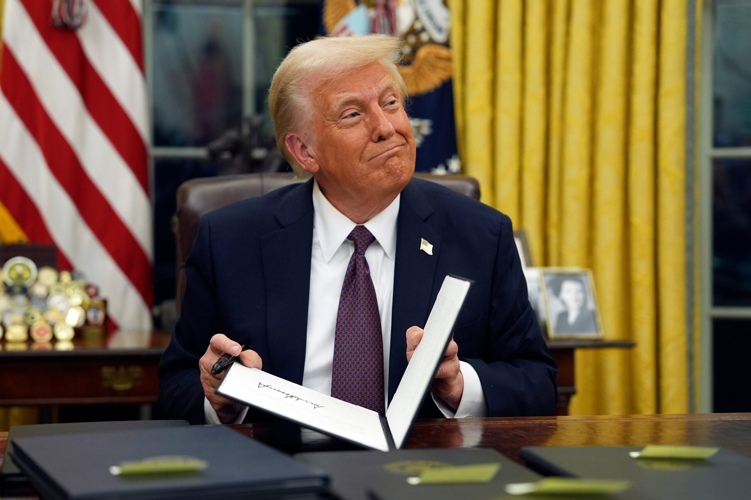 President Donald Trump signs executive orders in the Oval Office