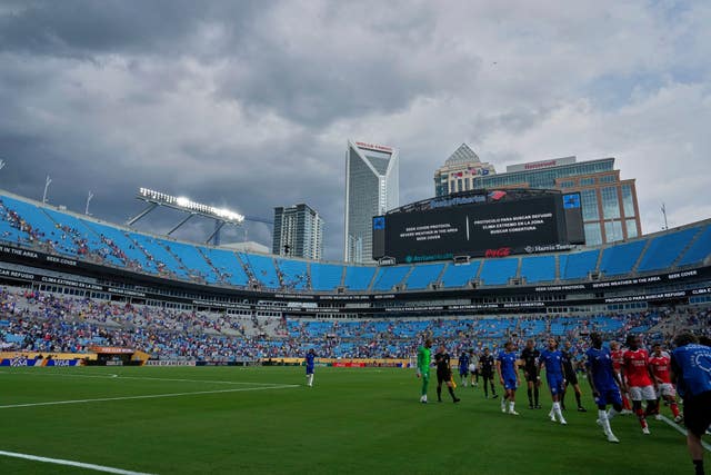 Players walk off the field for a weather delay during the Club World Cup between Chelsea and Benfica