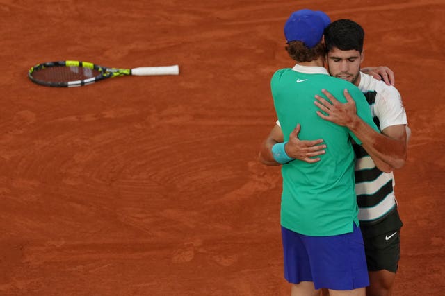 Jannik Sinner and Carlos Alcaraz embrace after the French Open final