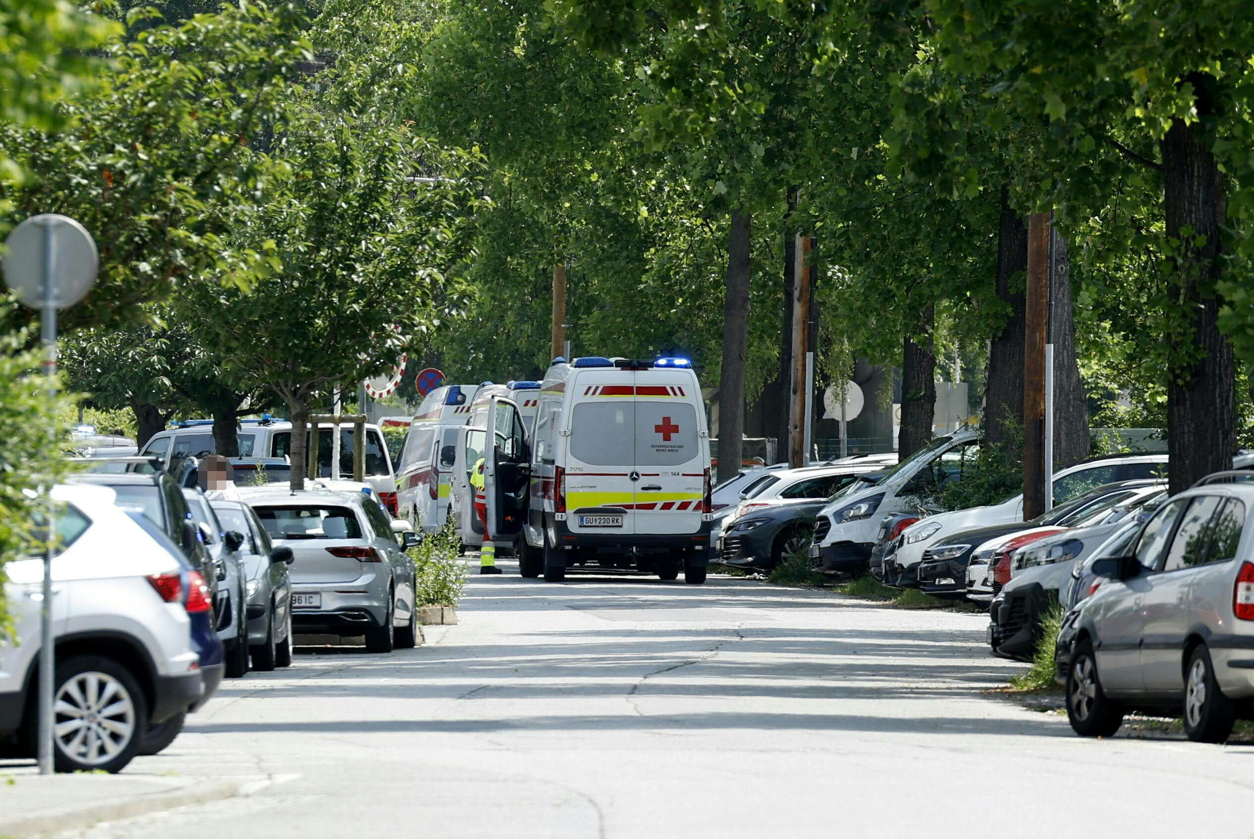 Ambulance cars are seen in a street close to a school where, according to reports, several people died in a shooting