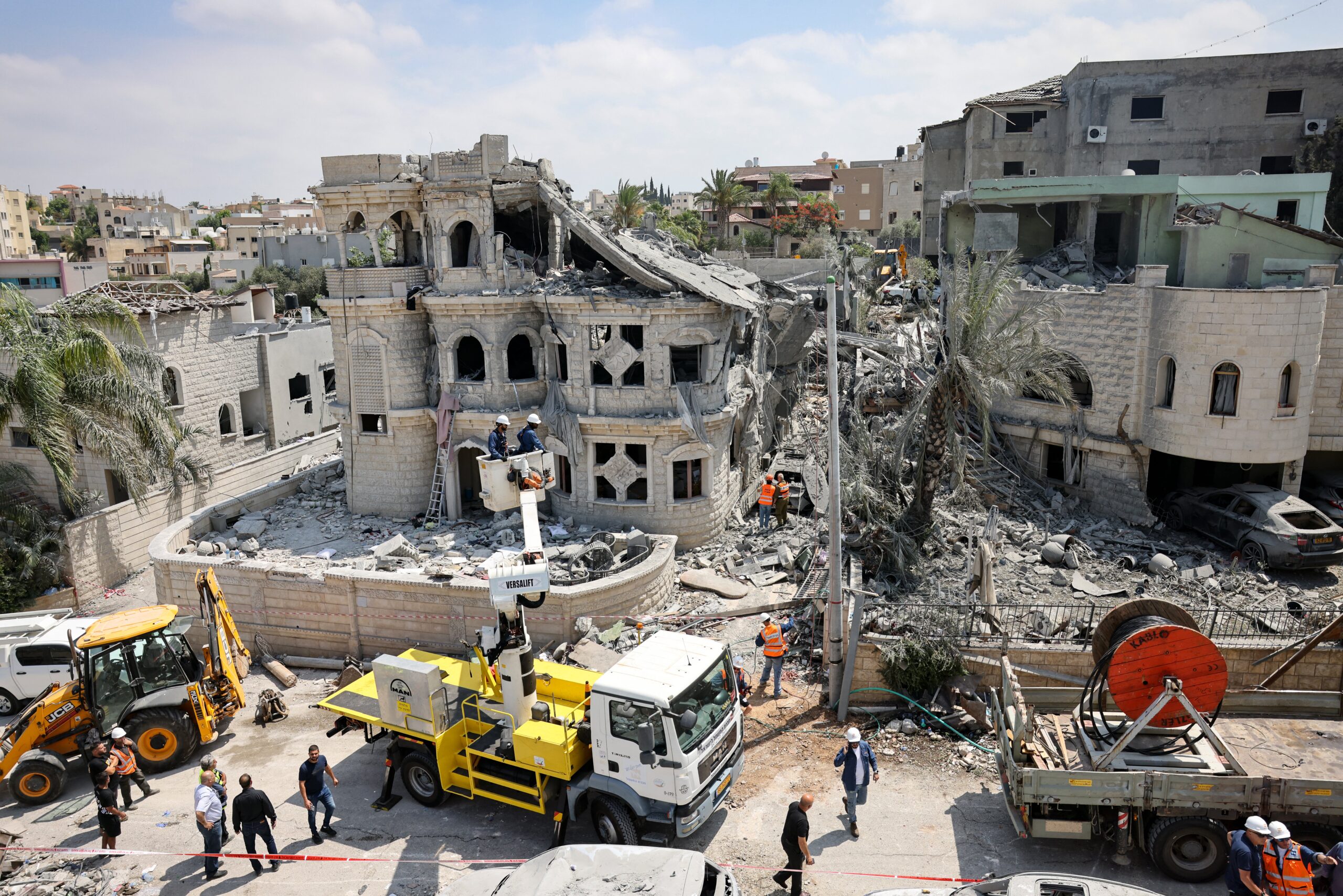 Rescue teams clear rubble in a neighbourhood in the northern Israeli town of Tamra following an overnight missile attack by Iran