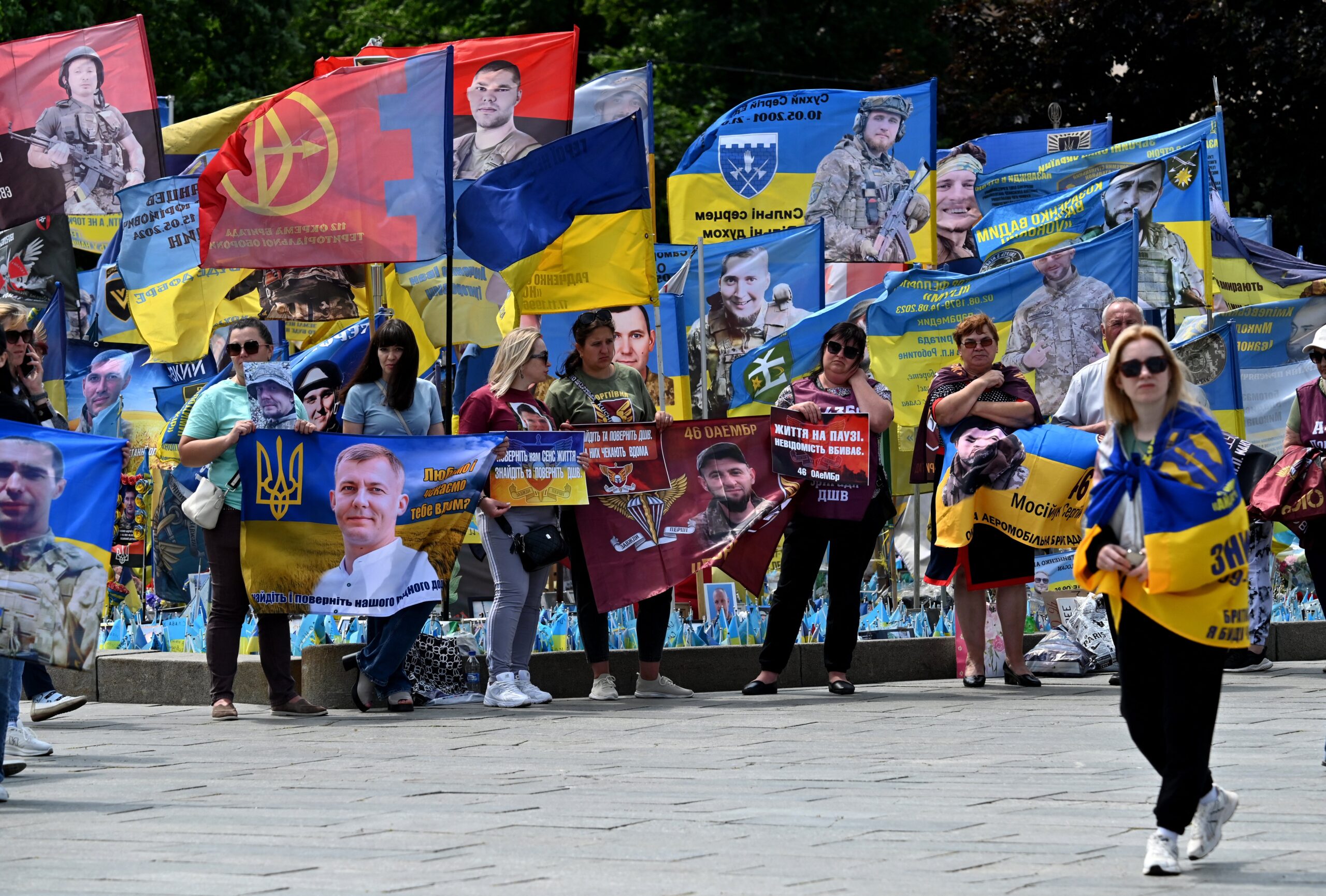 Relatives and friends of Ukrainian prisoners of war hold portraits of them during a rally