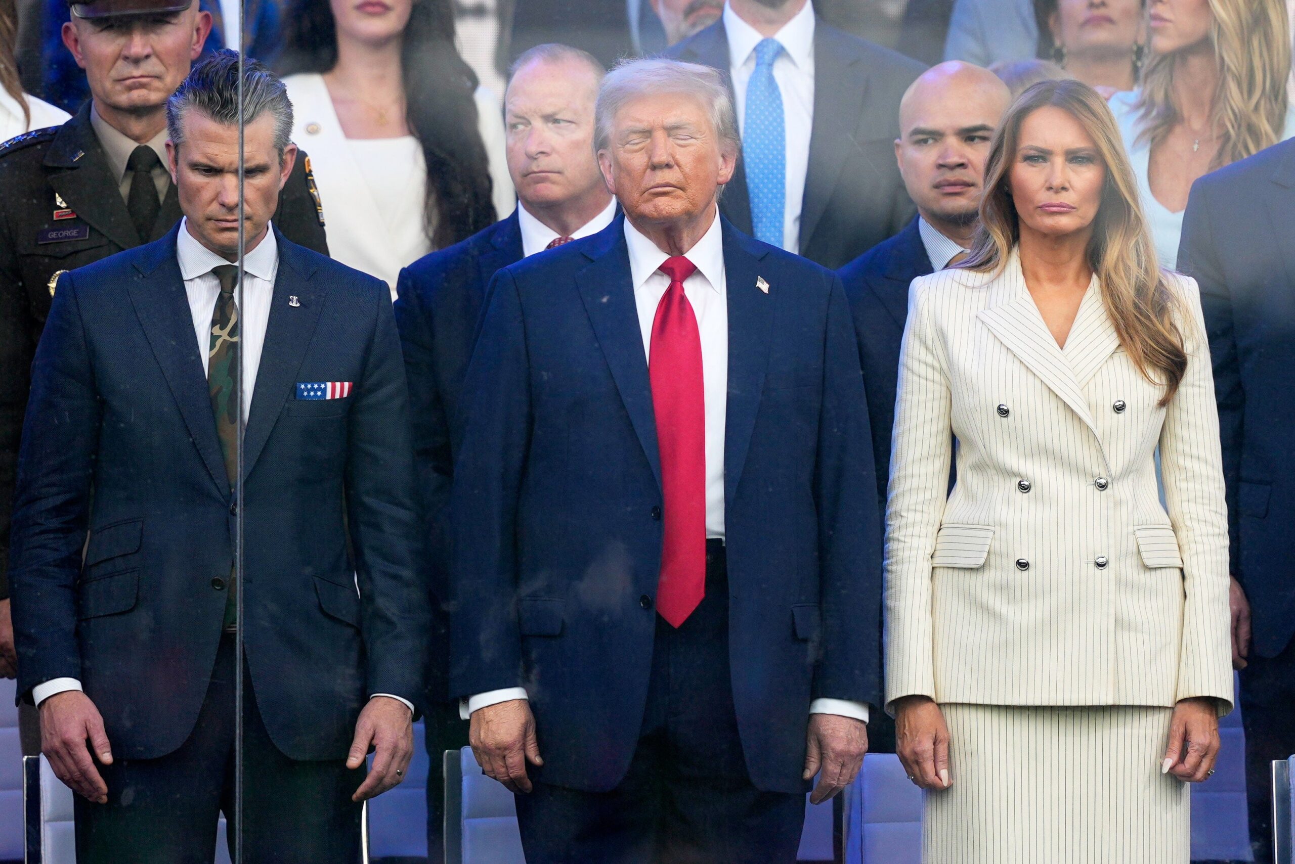 President Donald Trump, first lady Melania Trump and Defense Secretary Pete Hegseth attend a military parade commemorating