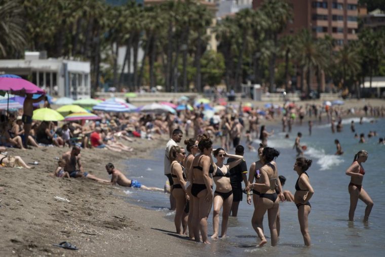 Beachgoers enjoy the sun and the sea at Malagueta beach in Malaga on May 25, 2025. (Photo by JORGE GUERRERO / AFP) (Photo by JORGE GUERRERO/AFP via Getty Images)