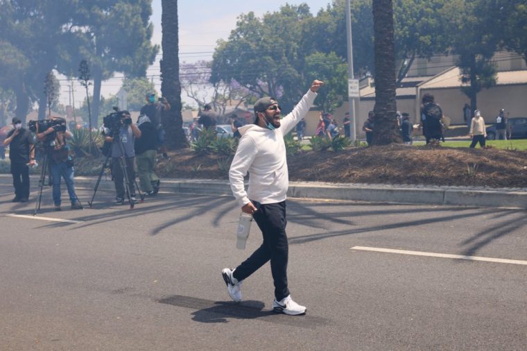 LOS ANGELES, CALIFORNIA - JUNE 7: Protests and confrontations between immigration rights supporters and law enforcement take place in Paramount and downtown Los Angeles, California, following recent raids by Immigration and Customs Enforcement (ICE) and Department of Homeland Security (DHS) agents on June 7, 2025. Demonstrators are seen using blockades and facing tear gas, flashbang grenades, and pepper ball shots, while rising tensions lead to damaged property across the affected areas. (Photo by Taurat Hossain/Anadolu via Getty Images)