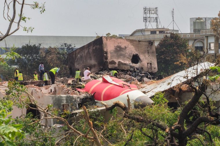 An investigation team inspects the wreckage of Air India flight 171 a day after it crashed in a residential area near the airport, in Ahmedabad on June 13, 2025. Investigators recovered a black box recorder from the crash site on June 13 of a London-bound passenger jet that ploughed into a residential area of India's Ahmedabad city, killing at least 265 people on board and on the ground. (Photo by Sam PANTHAKY / AFP) (Photo by SAM PANTHAKY/AFP via Getty Images)