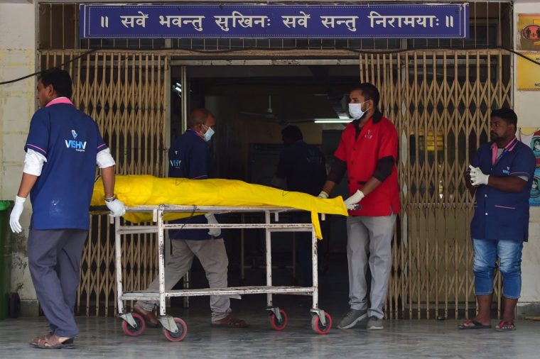 AHMEDABAD, INDIA - JUNE 13: Medical officials move dead body of victims to the cold storage who died in Air India Boeing 787 Crash at civil hospital on June 13, 2025 in Ahmedabad, India. An Air India Boeing 787 Dreamliner, flight AI-171, carrying 242 passengers and crew members en route from Ahmedabad to London Gatwick, crashed shortly after takeoff on June 12, 2025, after the pilot issued a mayday call to air traffic control. The aircraft crashed into the densely populated Meghani Nagar area near Sardar Vallabhbhai Patel International Airport, resulting in a massive explosion and fire due to the heavy fuel load for the international journey, with rescue operations ongoing. (Photo by Ritesh Shukla/Getty Images)