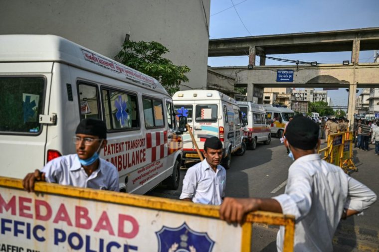 Ambulances are seen parked near the post-mortem room at a hospital before transferring victims' dead bodies to a mortuary in Ahmedabad on June 13, 2025, a day after Air India flight 171 crashed in a residential area near airport. Investigators recovered a black box recorder from the crash site on June 13 of a London-bound passenger jet that ploughed into a residential area of India's Ahmedabad city, killing at least 265 people on board and on the ground. (Photo by Punit PARANJPE / AFP) (Photo by PUNIT PARANJPE/AFP via Getty Images)