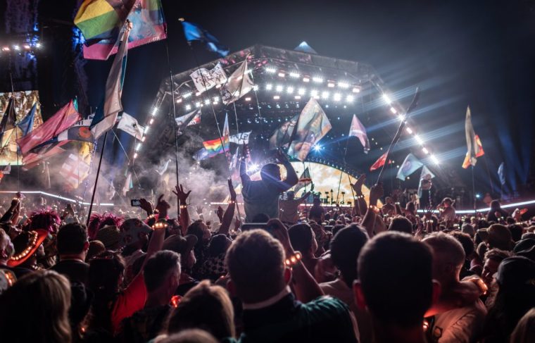 GLASTONBURY, ENGLAND - JUNE 29: People cheer as headliner Coldplay perform on the main Pyramid stage during day four of Glastonbury Festival 2024 at Worthy Farm, Pilton on June 29, 2024 in Glastonbury, England. Founded by Michael Eavis in 1970, Glastonbury Festival features around 3,000 performances across over 80 stages. Renowned for its vibrant atmosphere and iconic Pyramid Stage, the festival offers a diverse lineup of music and arts, embodying a spirit of community, creativity, and environmental consciousness. The Glastonbury Festival is set to return in June 2025, before having a fallow year in 2026. (Photo by Matt Cardy/Getty Images)