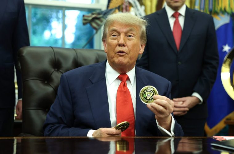 WASHINGTON, DC - JUNE 27: U.S. President Donald Trump holds a coin as he delivers remarks while meeting with Minister of Foreign Affairs and Cooperation of Rwanda Olivier Nduhungirehe and the Foreign Minister of the Democratic Republic of the Congo Th??r??se Kayikwamba Wagner in the Oval Office at the White House on June 27, 2025. The meeting took place as a peace agreement brokered by the White House, which hopes to end a conflict in eastern Democratic Republic of Congo, was signed by officials of the two African nations. (Photo by Joe Raedle/Getty Images)