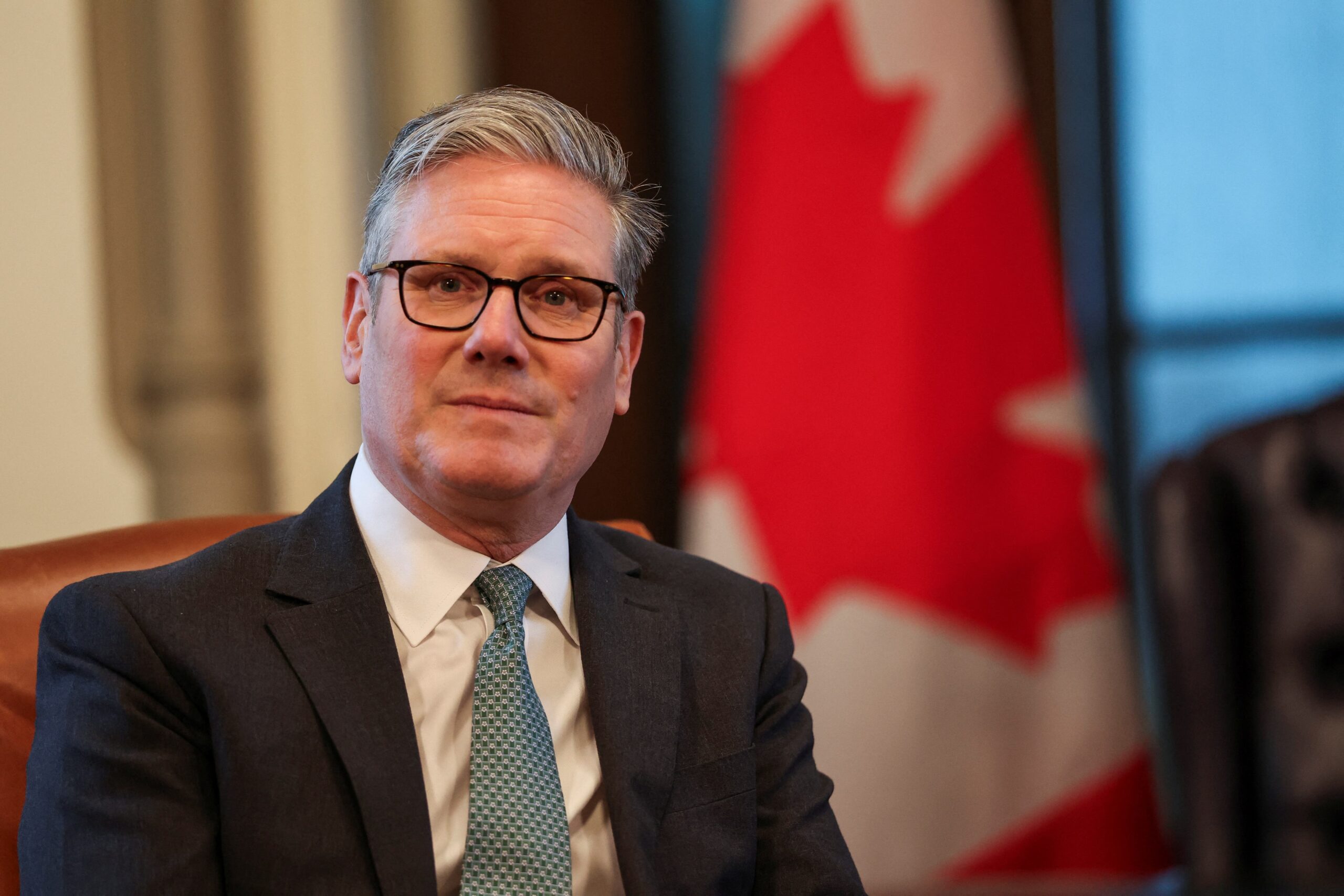 Sir Keir Starmer spoke to reporters while travelling to Canada for the G7 summit (PA)