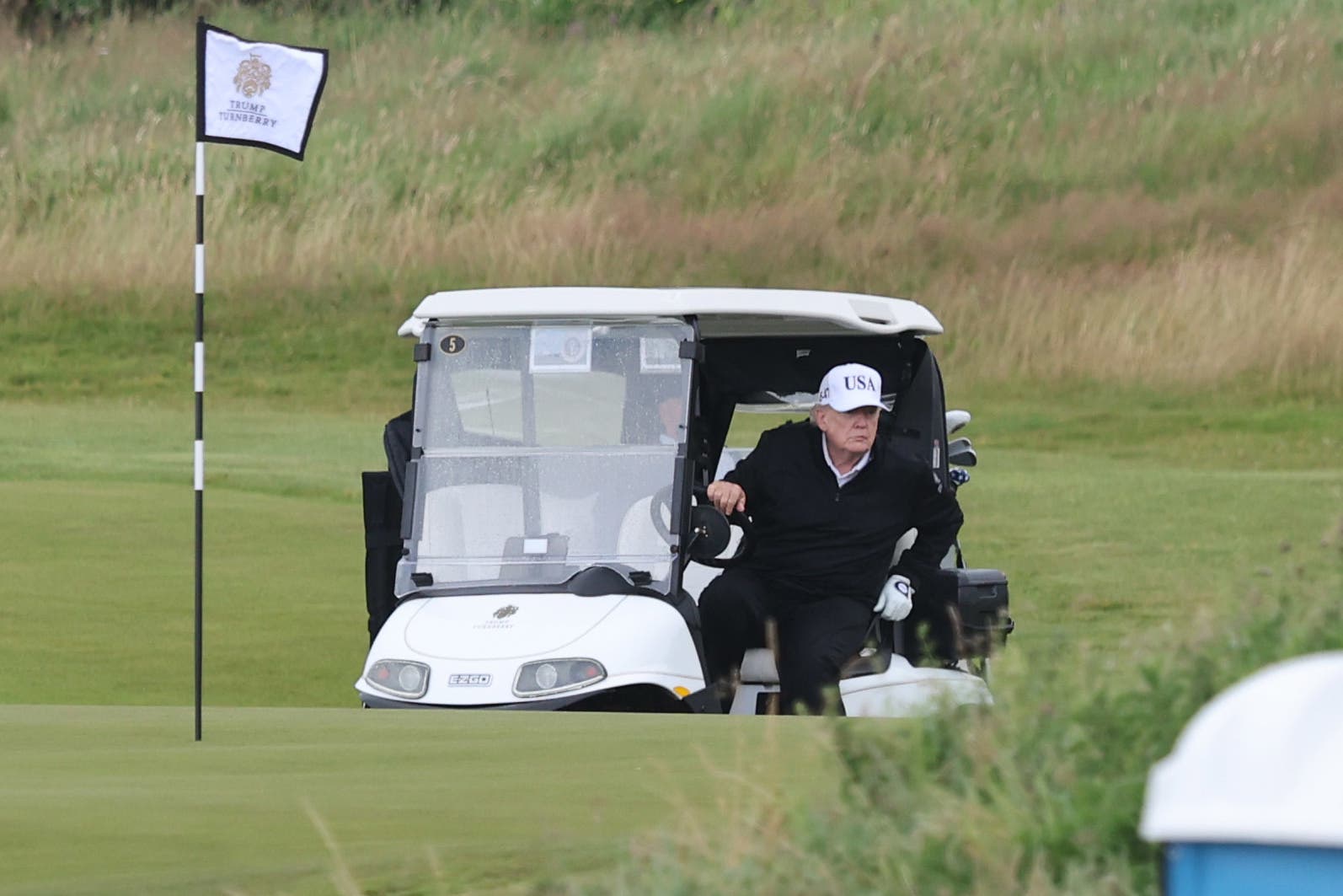 US President Donald Trump in a golf cart at his Trump Turnberry golf course in South Ayrshire