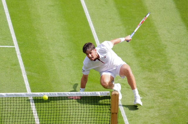 Cameron Norrie slides after hitting a shot