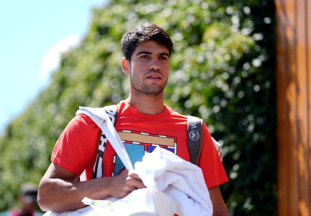 Carlos Alcaraz walks to the practice courts at Wimbledon