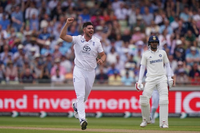 Josh Tongue celebrates taking the wicket of Ravindra Jadeja