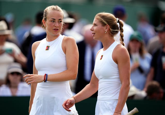 Hannah Klugman (right) and Mika Stojsavljevic talk to each other between points during a doubles match