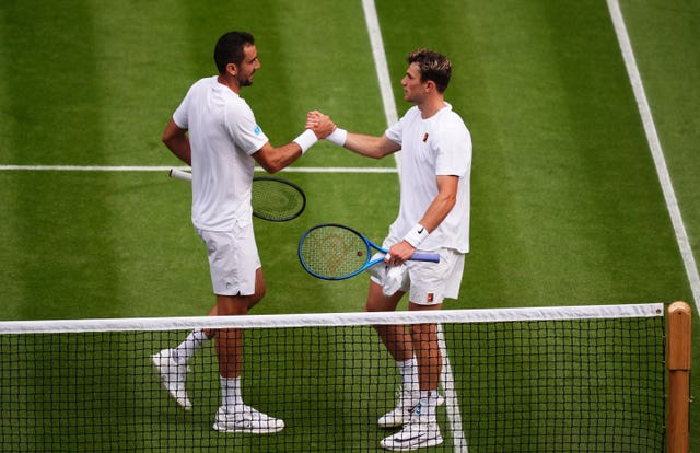 Jack Draper, right, shakes hands with Marin Cilic