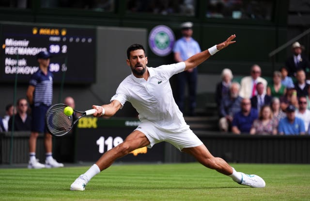 Novak Djokovic slides to hit a shot