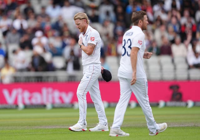 England captain Ben Stokes, left, rubs his shoulder after bowling against India in the fourth Test