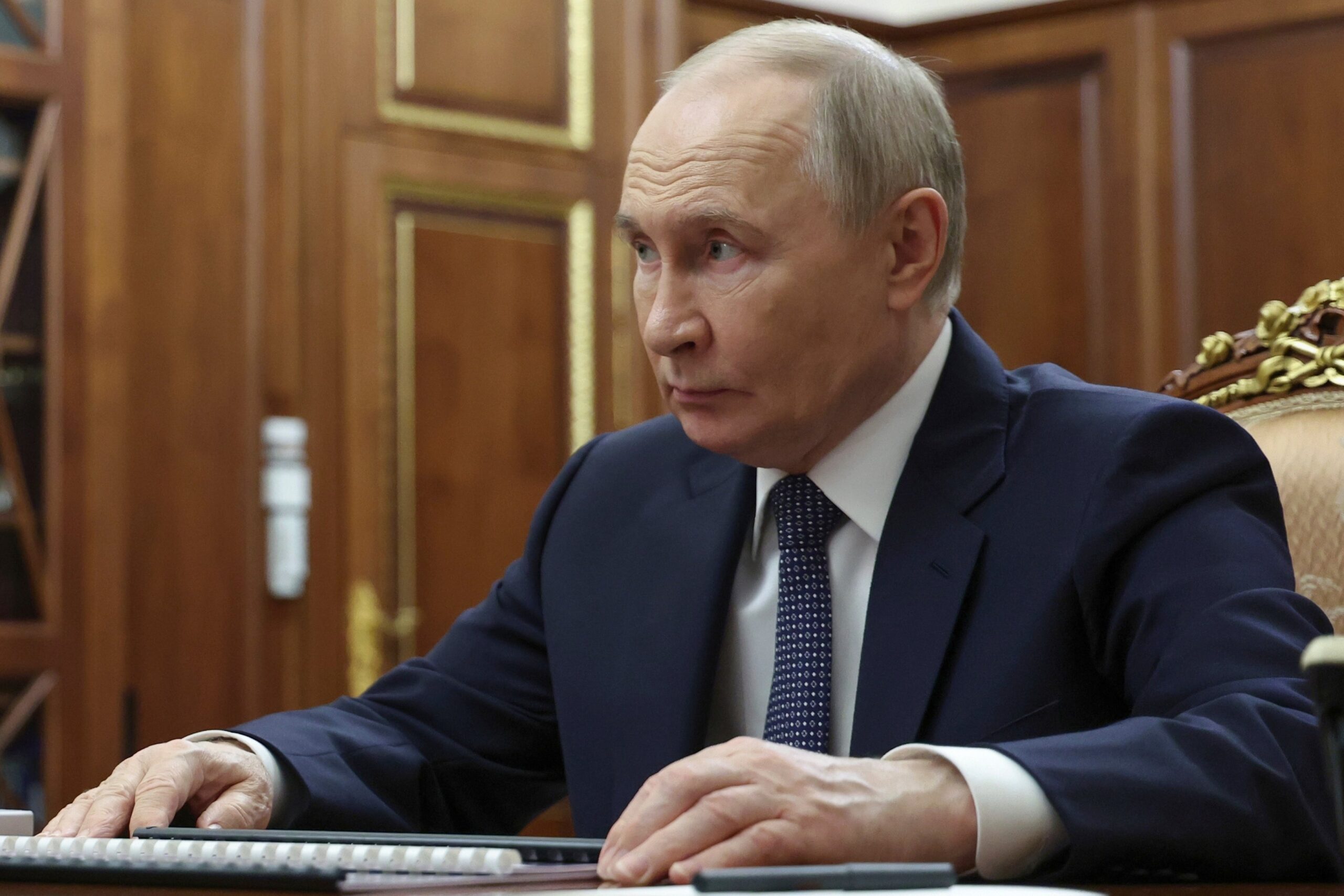 Russian president Vladimir Putin listens to minister of justice of the Russian Federation Konstantin Chuychenko during their meeting at the Kremlin in Moscow