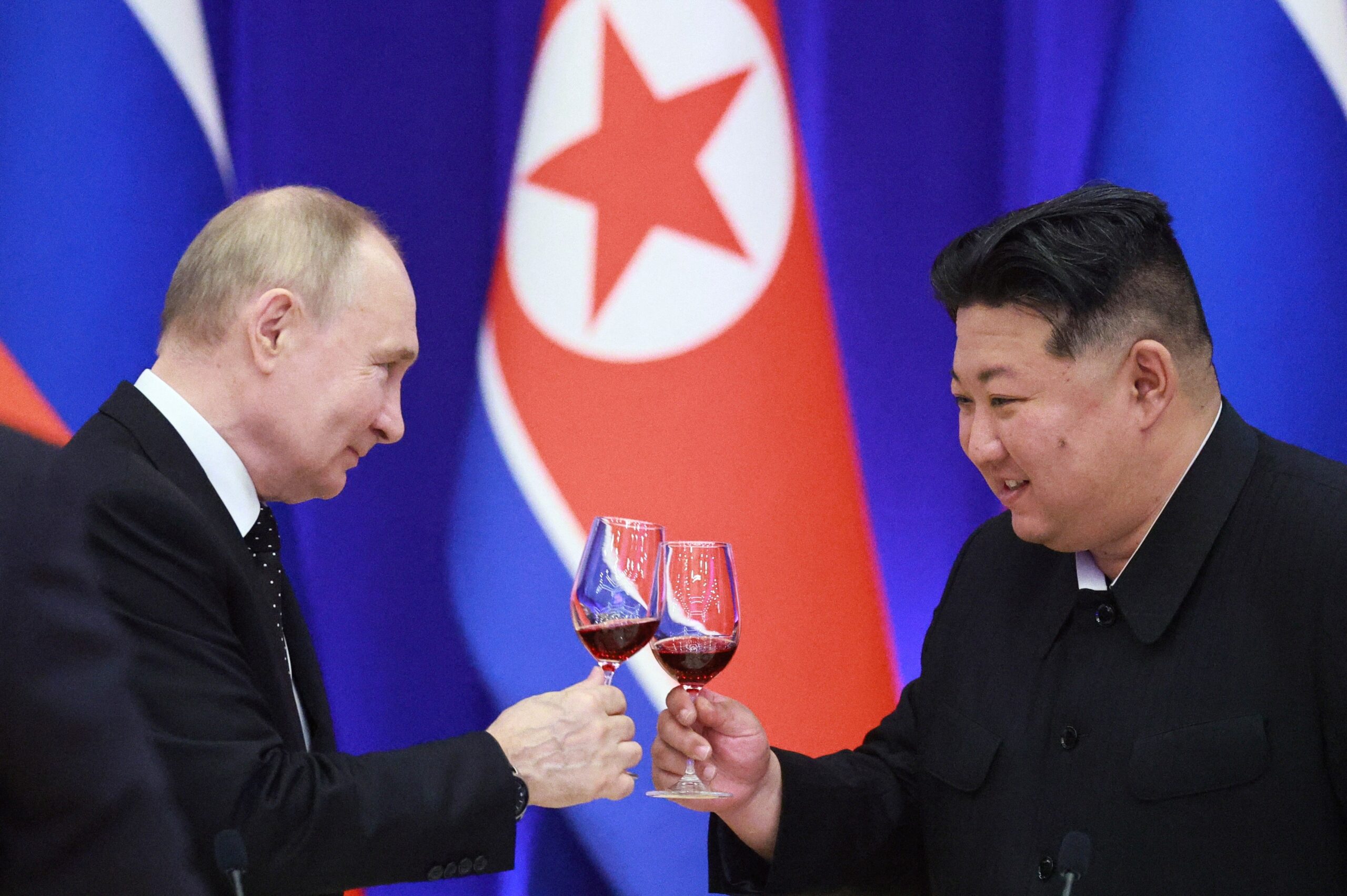 Russian President Vladimir Putin and North Korean leader Kim Jong Un toast during a reception at the Mongnangwan Reception House in Pyongyang on June 19, 2024