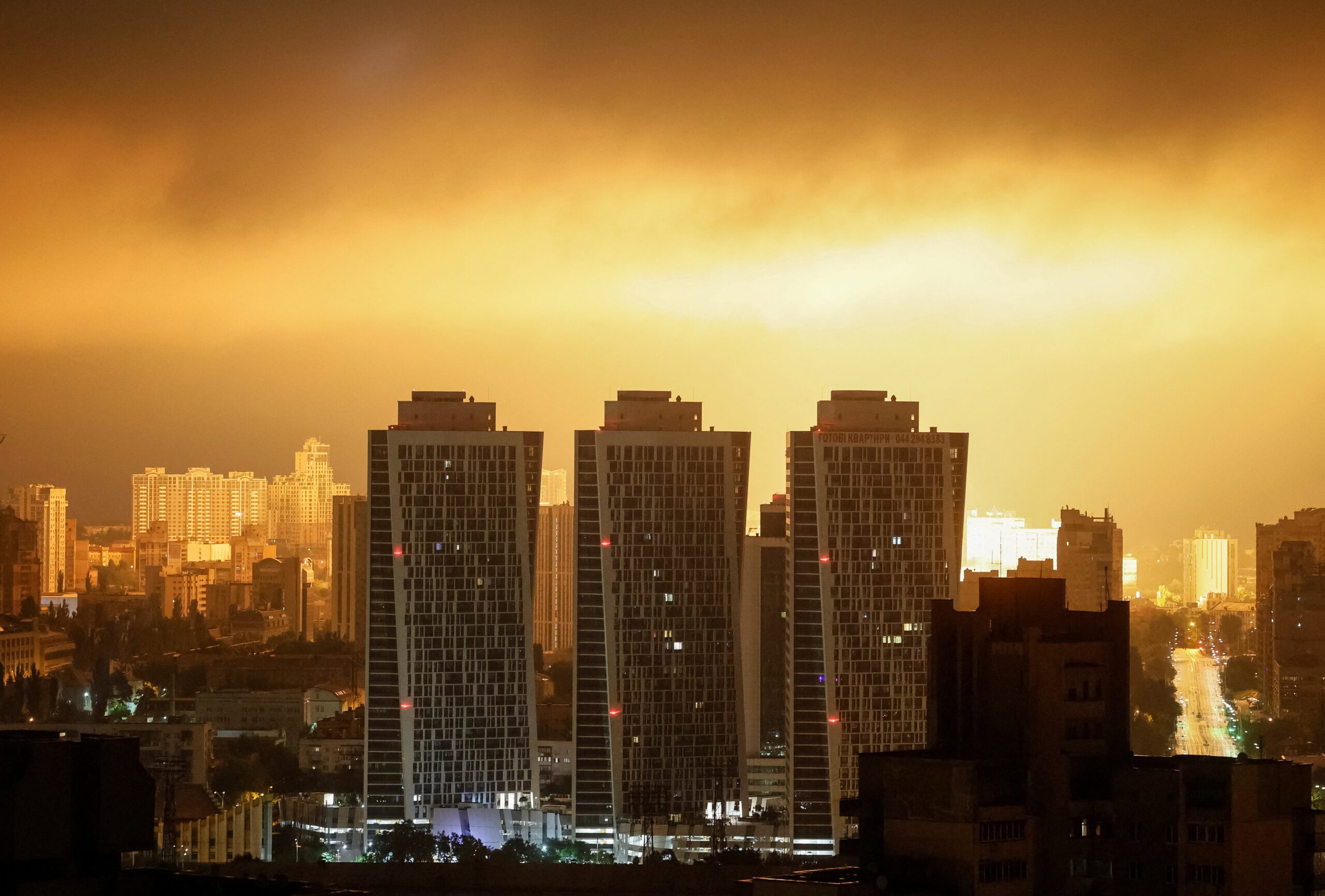 File: An explosion of a drone lights up the sky over the city during a Russian drone and missile strike in Kyiv