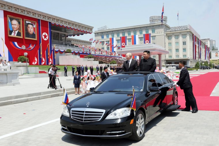 In this pool photograph distributed by the Russian state agency Sputnik, North Korea's leader Kim Jong Un (R) and Russian President Vladimir Putin attend a welcoming ceremony at Kim Il Sung Square in Pyongyang on June 19, 2024. Russian President Vladimir Putin landed in North Korea early on June 19, the Kremlin said, kicking off a visit set to boost defence ties between the two nuclear-armed countries as Moscow pursues its war in Ukraine. (Photo by Gavriil GRIGOROV / POOL / AFP) / -- Editor's note : this image is distributed by the Russian state owned agency Sputnik -- (Photo by GAVRIIL GRIGOROV/POOL/AFP via Getty Images)
