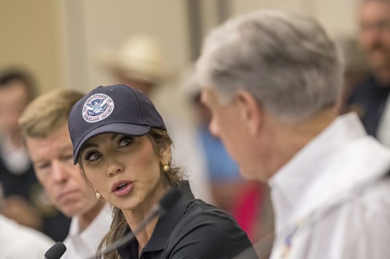 Homeland Security Secretary Kristi Noem, center, speaks with Texas Gov. Greg Abbott, right, about ongoing search and rescue efforts after recent flooding along the Guadalupe River during a press conference on Saturday, July 5, 2025, in Ingram, Texas. (AP Photo/Rodolfo Gonzalez)