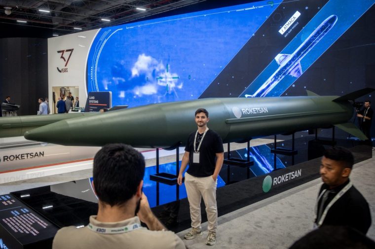 ISTANBUL, TURKEY - JULY 24: People pose for photographs in front of the Roketsan Tayfun hypersonic missile at Turkey's 17th International Defense Industry Fair (IDEF) In Istanbul on July 24, 2025 in Istanbul, Turkey. Turkish and foreign companies showcased defense technology and weaponry at the fair running from July 22-27. (Photo by Chris McGrath/Getty Images)
