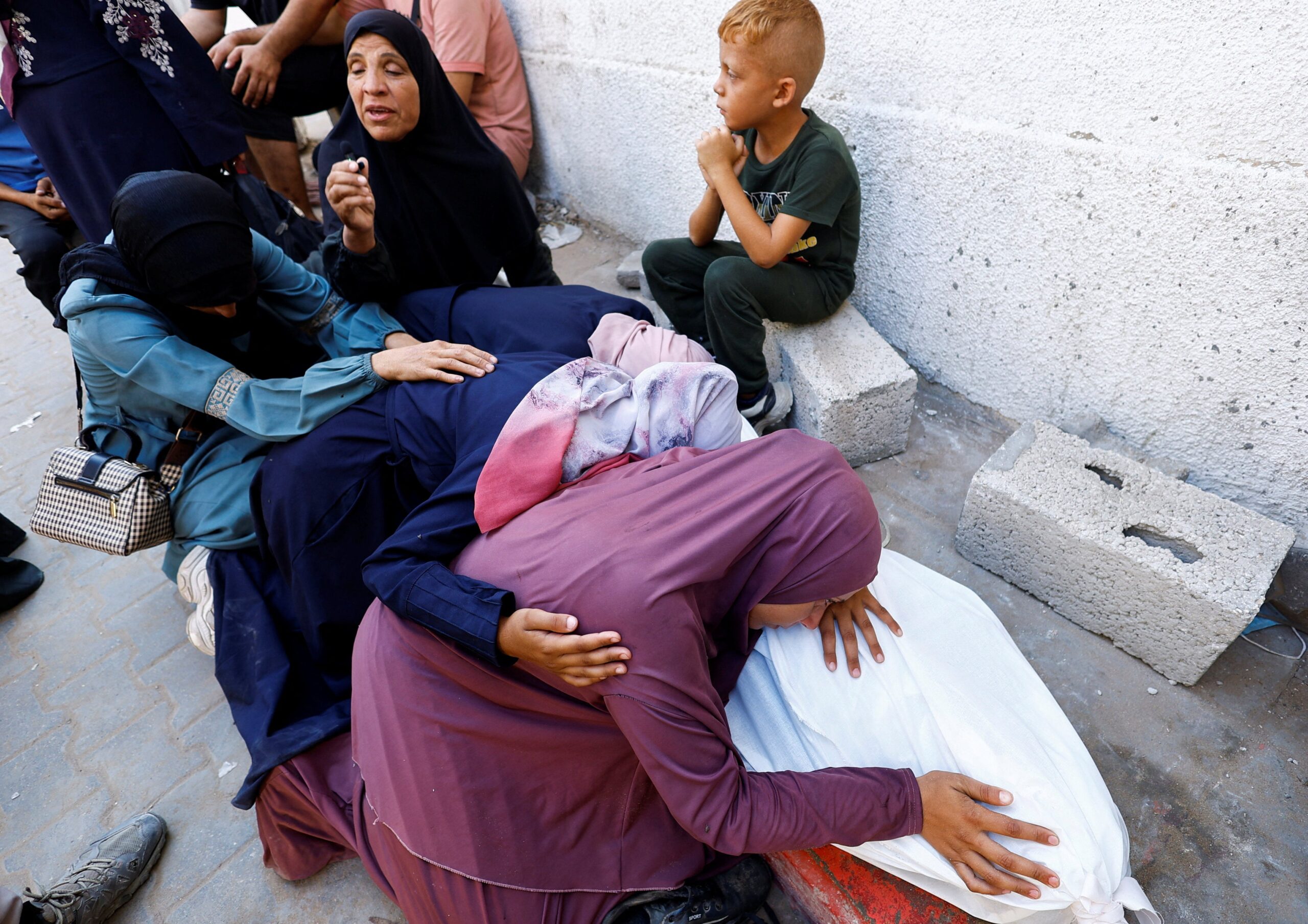The mother of Palestinian Mohammed Al-Motawak, who was killed by Israeli fire while trying to receive aid on Sunday, according to medics, mourns over his body during his funeral at Al-Shifa Hospital, in Gaza City