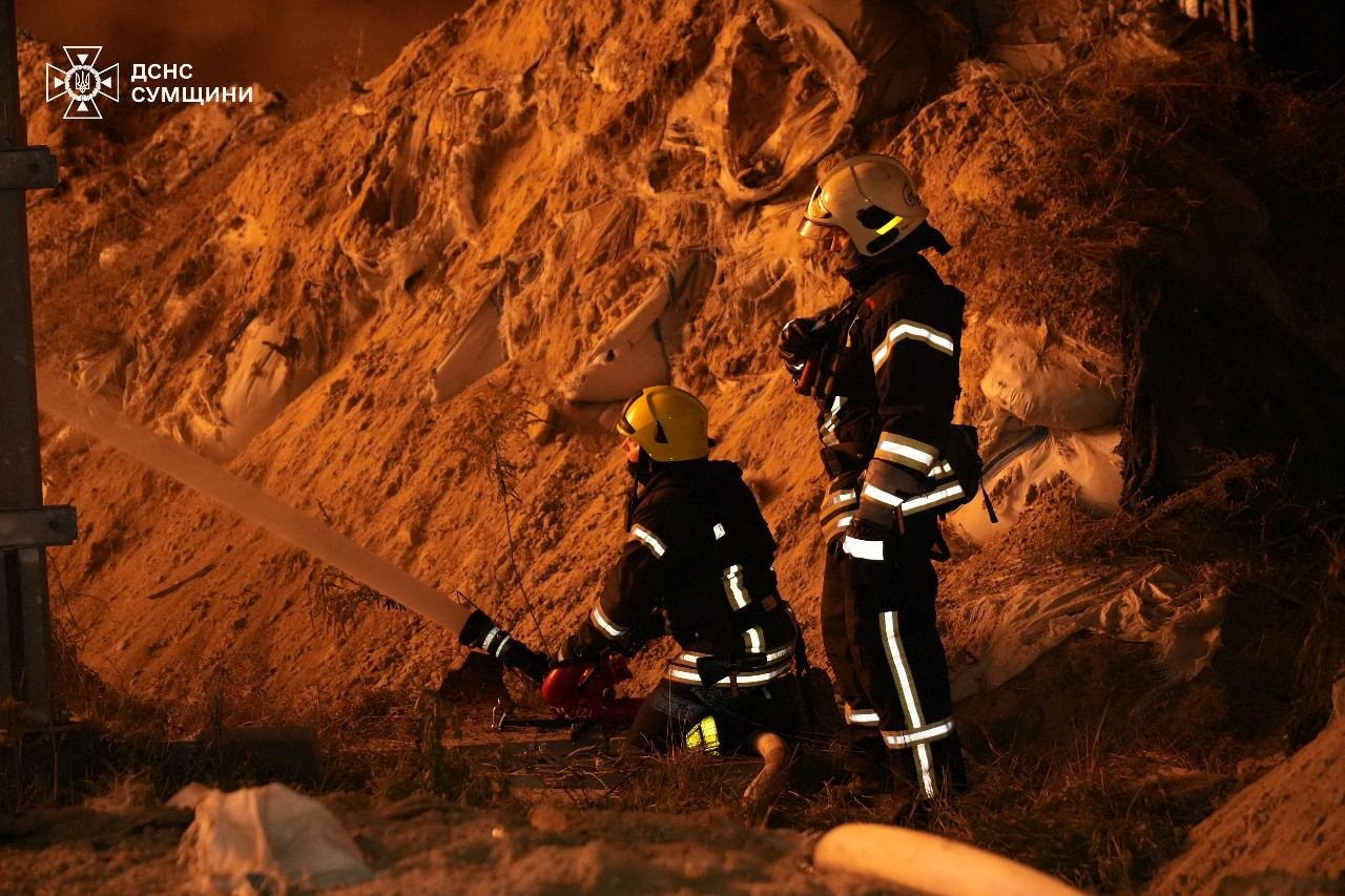 Firefighters work at the site of a Russian drone strike