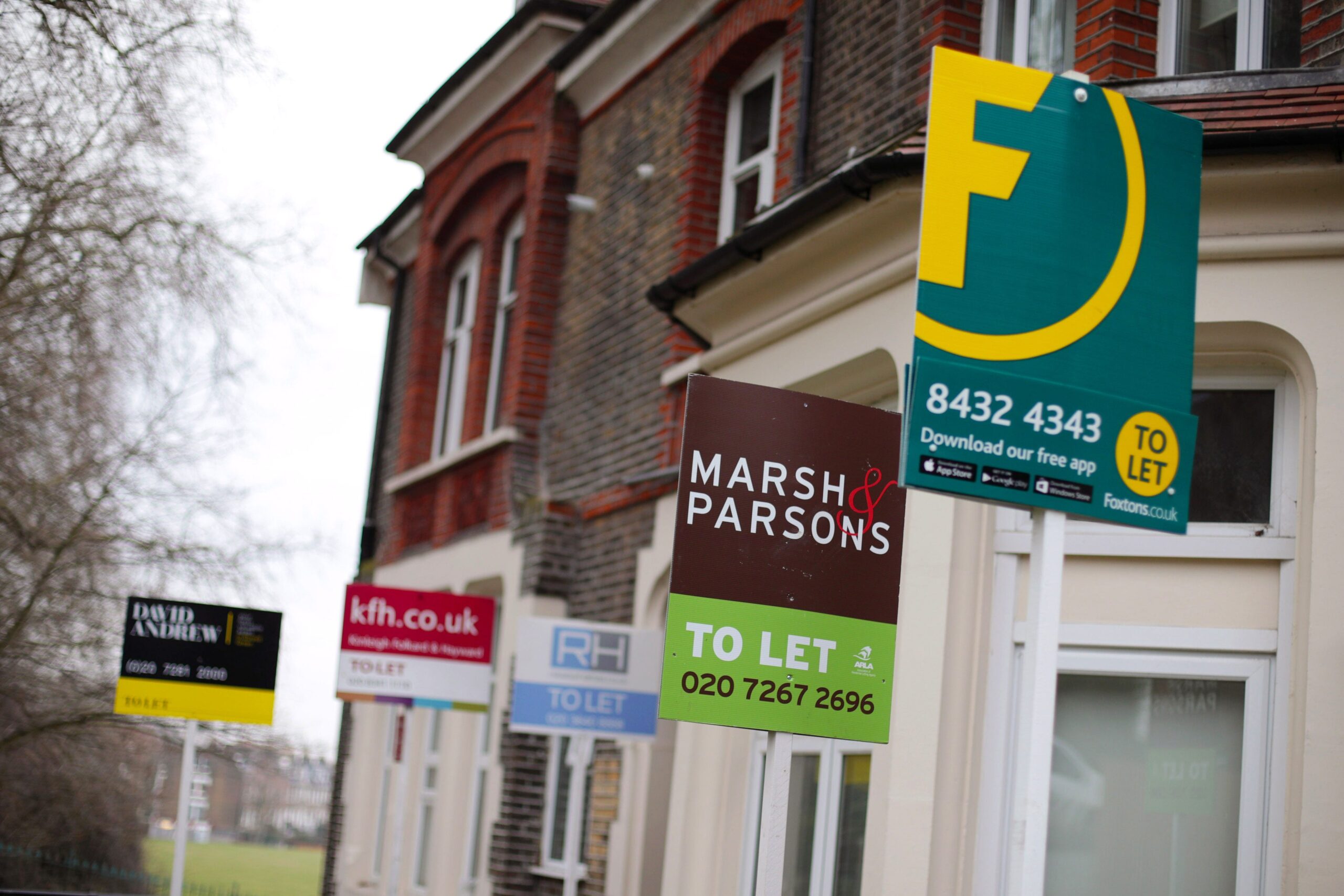 Estate agent signs outside homes in north London