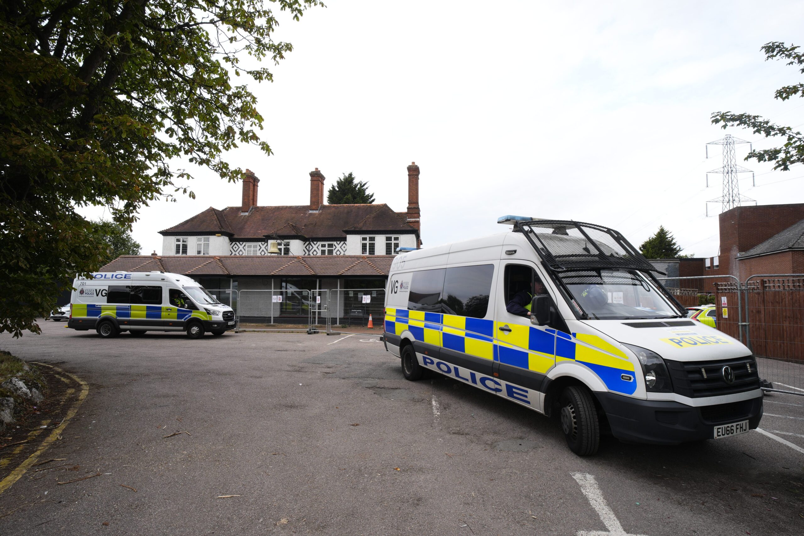 Police vans outside the Bell Hotel in Epping