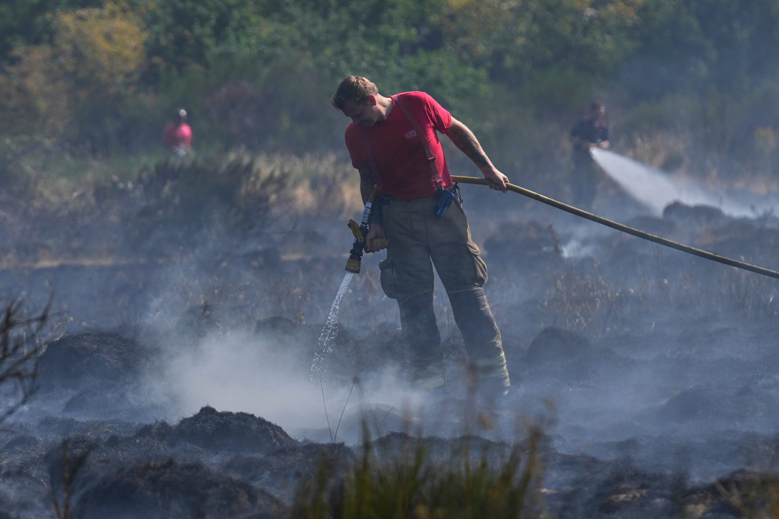 Members of the London Fire Brigade tackle a wildfire on Wanstead Flats in London this month