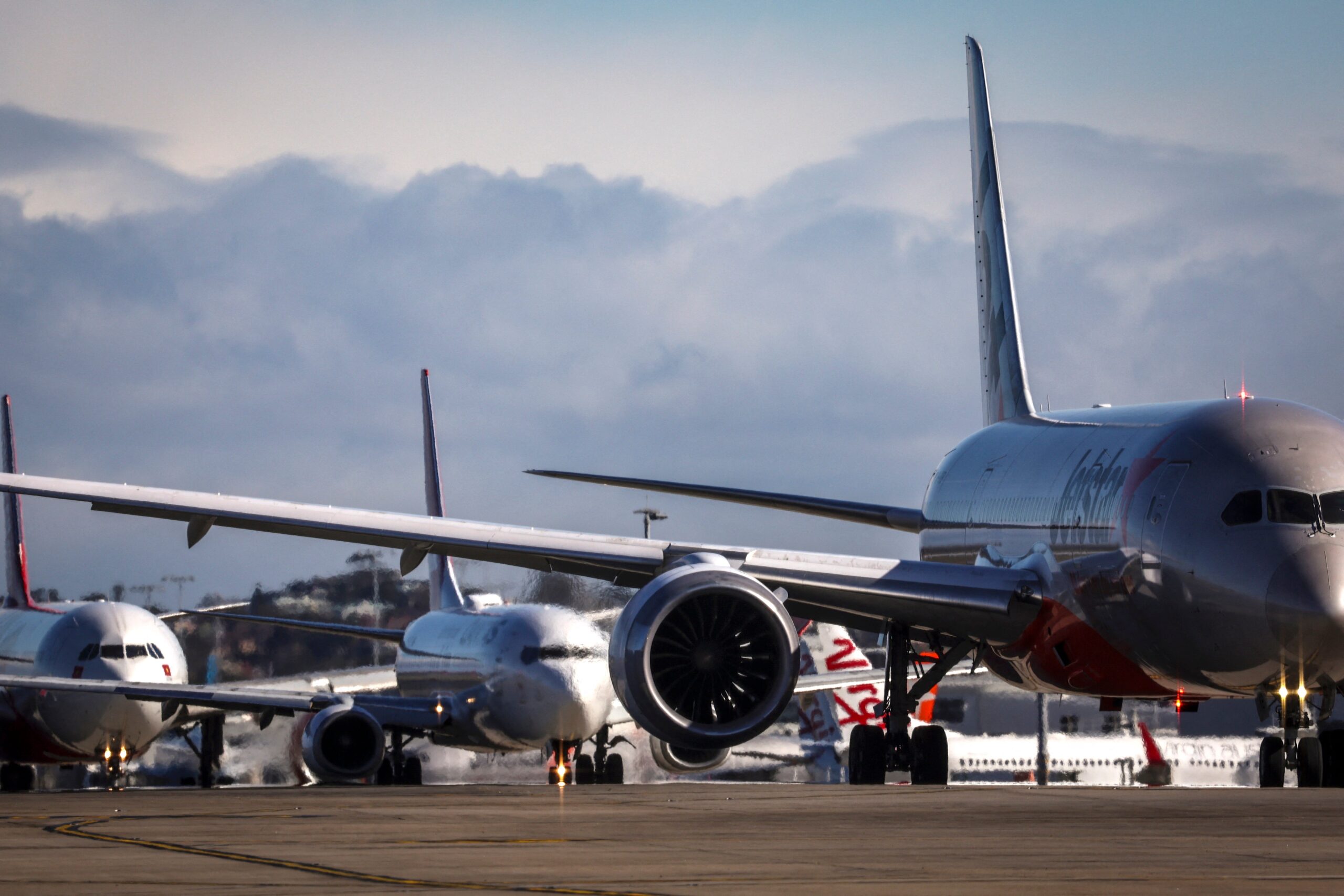 Aircrafts line up at Sydney International Airport on 25 June 2025