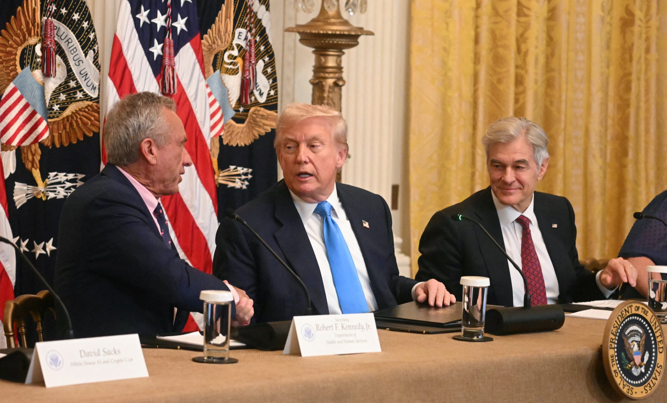 US Secretary of Health and Human Services Robert F. Kennedy Jr. shakes hands with US President Donald Trump.
