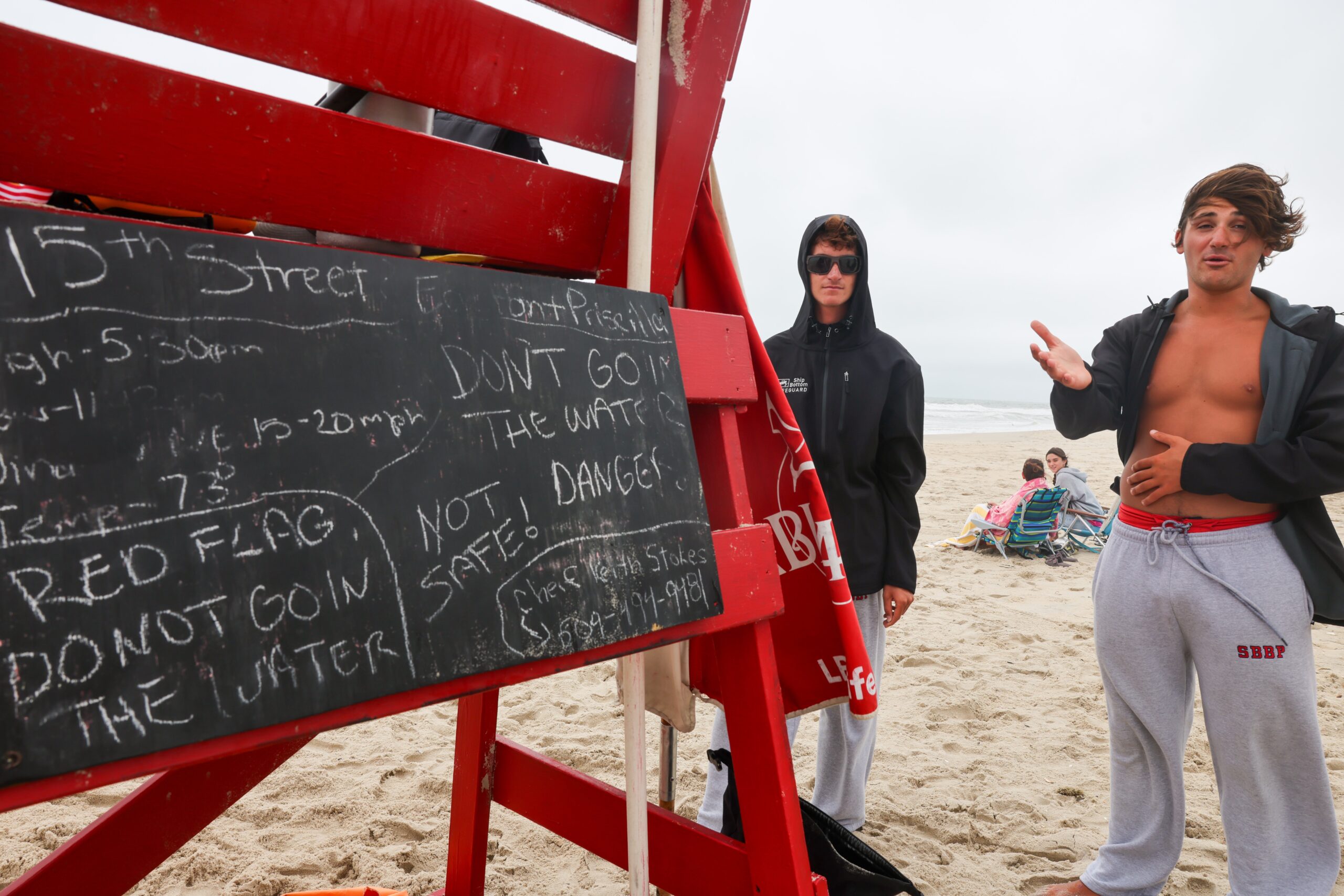 Lifeguards stand along a beach closed to swimmers due to strong riptides and high surf from Hurricane Erin in Surf City, Long Beach Island, New Jersey