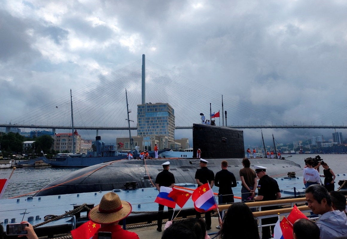 People take part in a ceremony marking the start of the upcoming Russian-Chinese joint naval drills in the Sea of Japan, following the arrival of Chinese military vessels in Vladivostok in Russia
