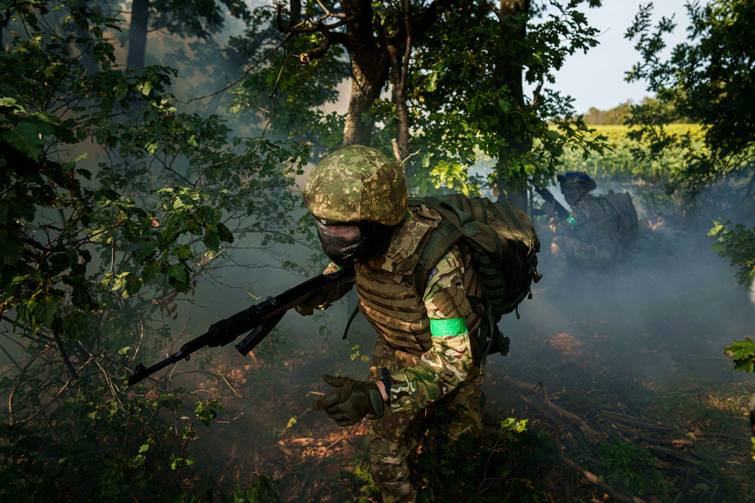 A Ukrainian National Guard serviceman of 3rd brigade Spartan runs through a tree line during a training not far from the frontline on Pokrovsk direction