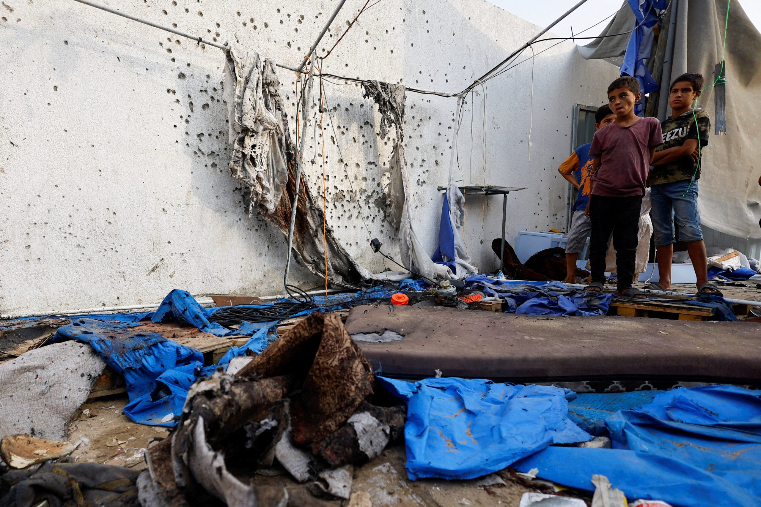 Palestinian children stands at the site of an Israeli strike on a tent near Shifa Hospital where Al Jazeera journalists Anas Al Sharif, Mohammed Qreiqeh, Ibrahim Zaher, and Mohammed Noufal were killed, in Gaza City August 11, 2025