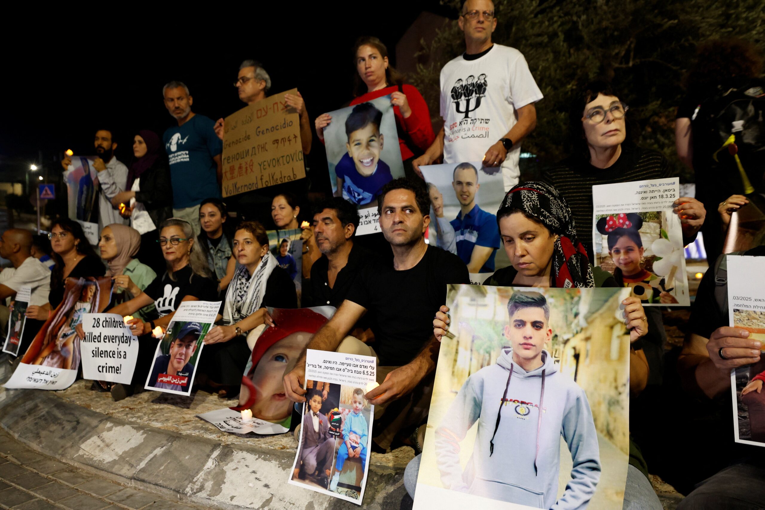 Demonstrators hold pictures as Palestinian and Israeli activists take part in a protest against starvation in Gaza, near Beit Jala, in the Israeli-occupied West Bank