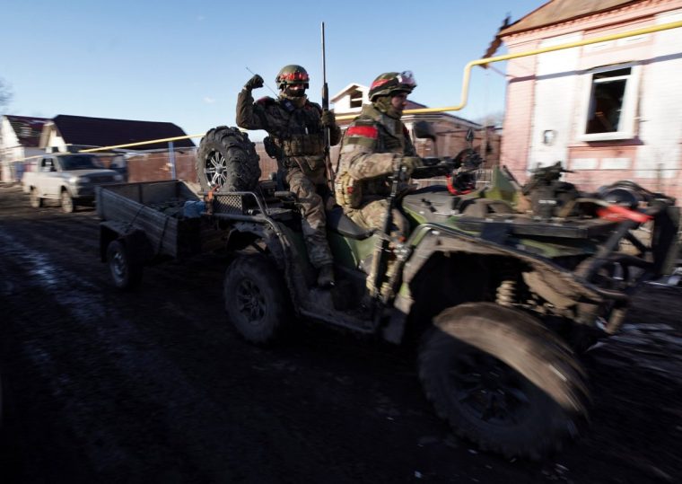TOPSHOT - Russian soldiers ride a quad bike (ATV) in the village of Kazachya Loknya, which was previously held by Ukrainian troops and recently retaken by Russia's armed forces, in the Sudzha district of the Kursk region on March 18, 2025, amid the ongoing Russian-Ukrainian conflict. (Photo by TATYANA MAKEYEVA / AFP) (Photo by TATYANA MAKEYEVA/AFP via Getty Images)