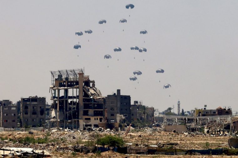 Aid pallets are parachuted after being dropped from a military plane over Nuseirat in the central Gaza Strip during an airdrop mission above the Israel-besieged Palestinian territory on August 4, 2025. (Photo by AFP) (Photo by -/AFP via Getty Images)