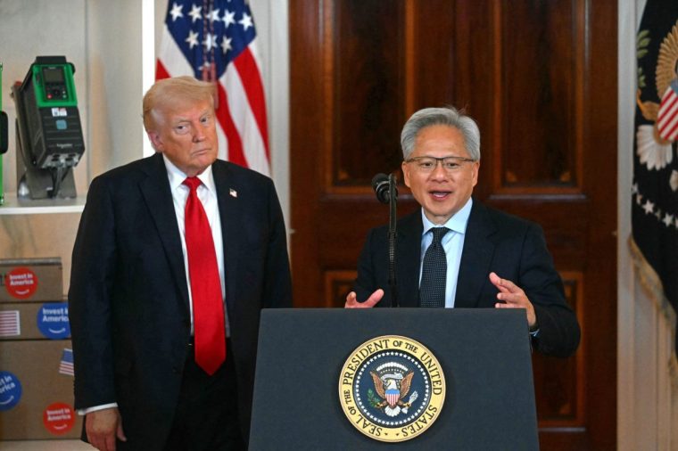 (FILES) Nvidia CEO Jensen Huang (R) speaks alongside US President Donald Trump about investing in America, at the White House in Washington, DC, on April 30, 2025. US semiconductor giants Nvidia and Advanced Micro Devices have agreed to pay the United States government 15 percent of their revenue from selling artificial intelligence chips to China, according to media reports on August 10, 2025. Nvidia CEO Jensen Huang met with US President Donald Trump at the White House on August 6 and agreed to give the federal government the cut from its revenues, a highly unusual arrangement in the international tech trade, according to reports in the Financial Times, Bloomberg and New York Times. (Photo by Jim WATSON / AFP) (Photo by JIM WATSON/AFP via Getty Images)