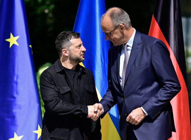 German Chancellor Friedrich Merz welcomes Ukrainian President Volodymyr Zelenskiy (L) upon his arrival in the garden of the chancellery in Berlin to join a video conference of European leaders with the US President on the Ukraine war ahead of the summit between the US and Russian leaders, on August 13, 2025. European leaders will hold online talks with US President Donald Trump, hoping to convince him to respect Ukraine's interests when he discusses the war with Putin in Alaska on Friday. JOHN MACDOUGALL/Pool via REUTERS