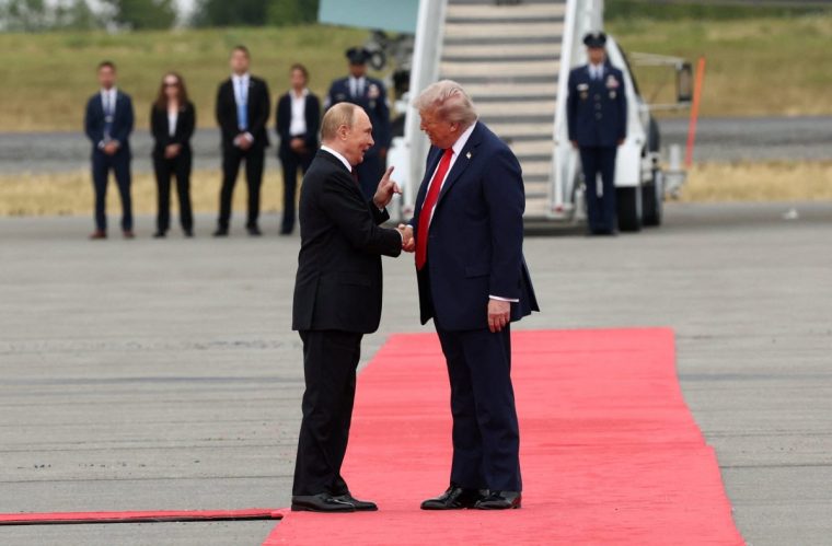 U.S. President Donald Trump shakes hand with Russian President Vladimir Putin, as they meet to negotiate for an end to the war in Ukraine, at Joint Base Elmendorf-Richardson in Anchorage, Alaska, U.S., August 15, 2025. REUTERS/Kevin Lamarque