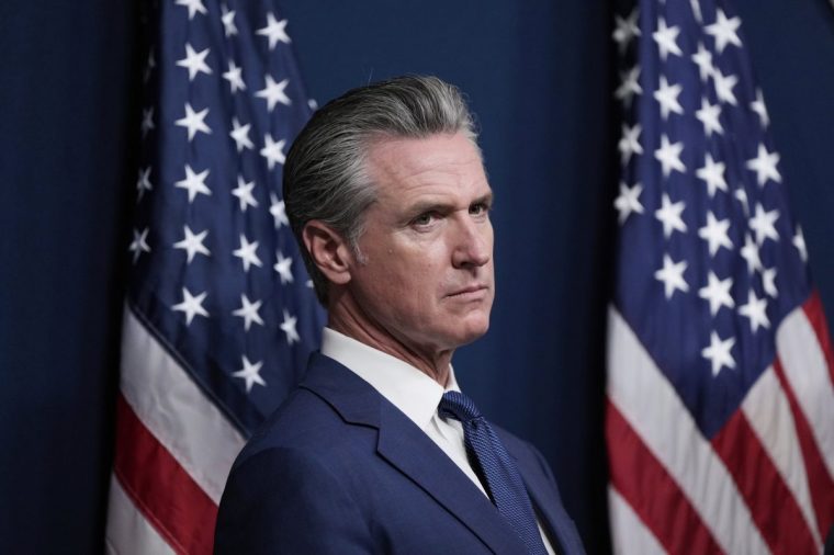 California Gov. Gavin Newsom prepares to speak before signing legislation calling for a special election on a redrawn congressional map on Thursday, Aug. 21, 2025, in Sacramento, Calif. (AP Photo/Godofredo A. V??squez)