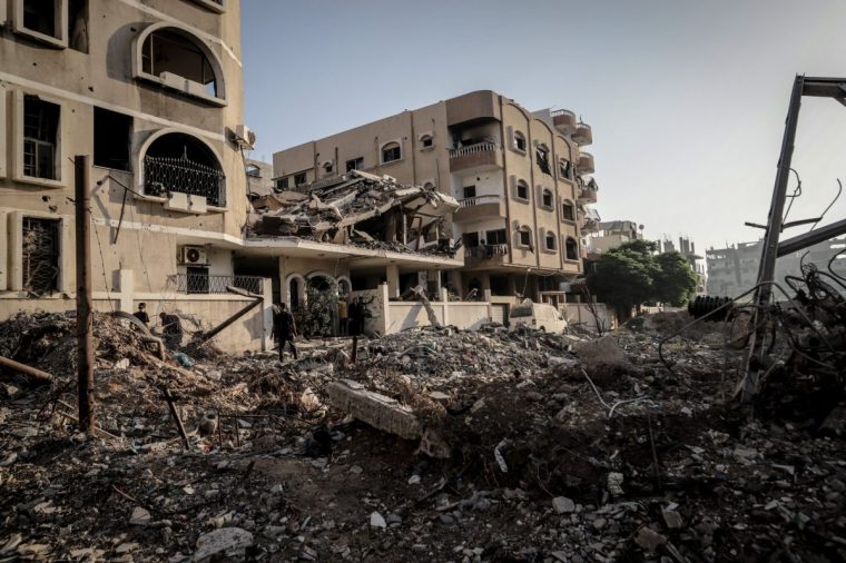GAZA CITY, GAZA - AUGUST 25: Residents launch search and rescue efforts to locate those trapped under the rubble after an Israeli strike targeted a building belonging to the Kaheel family in the Al-Karama neighborhood of Gaza City, Gaza, on August 25, 2025. Several people were reported killed and injured. The building was destroyed in the attack, and nearby structures also sustained damage. (Photo by Saeed M. M. T. Jaras/Anadolu via Getty Images)